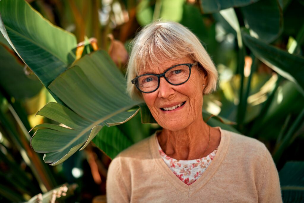 senior-on-the-beach Senior Woman in front of Birds of Paradise plants
